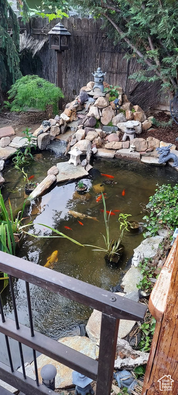 Exterior details featuring a garden pond and fence