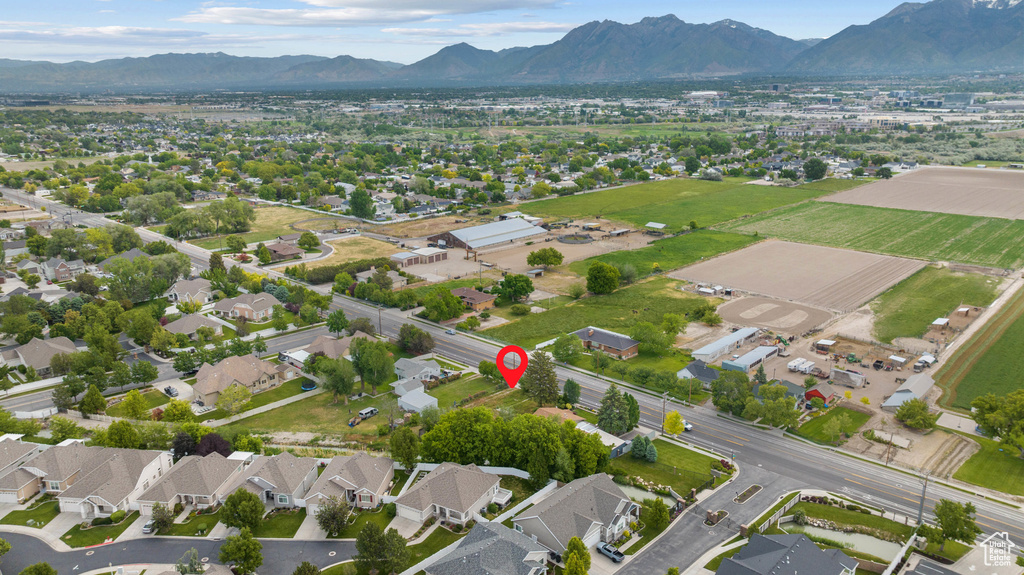 Aerial view of property's location featuring a mountainous background and nearby suburban area