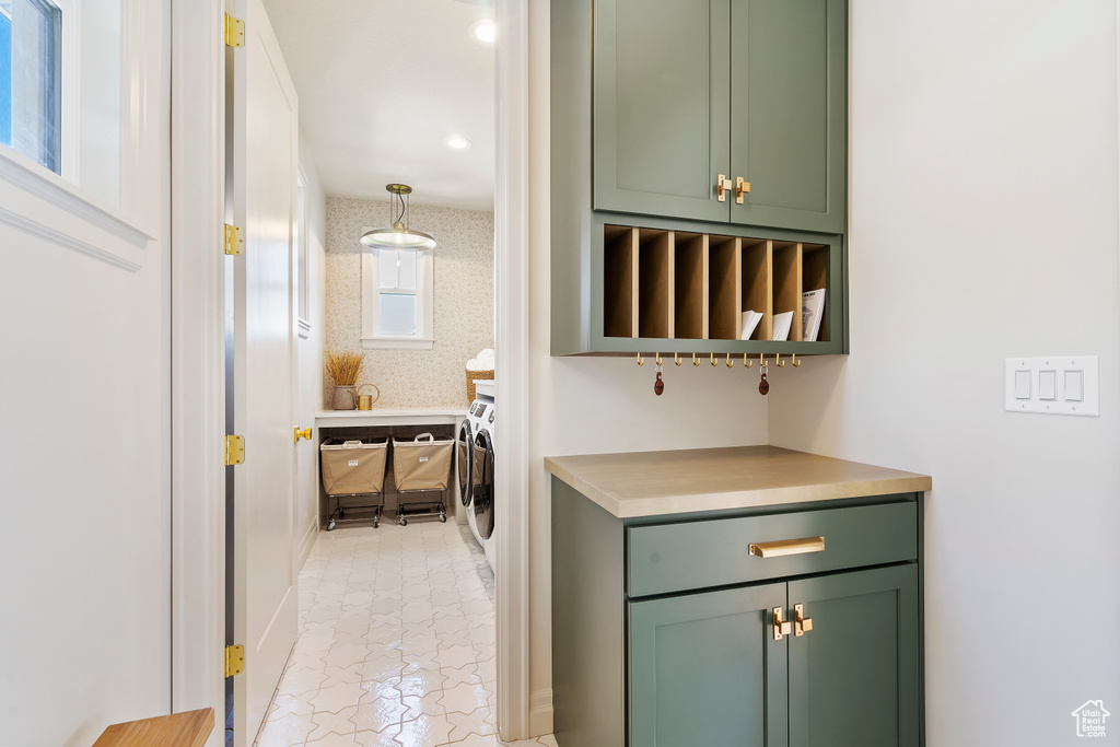 Bar featuring washing machine and clothes dryer and wallpapered walls