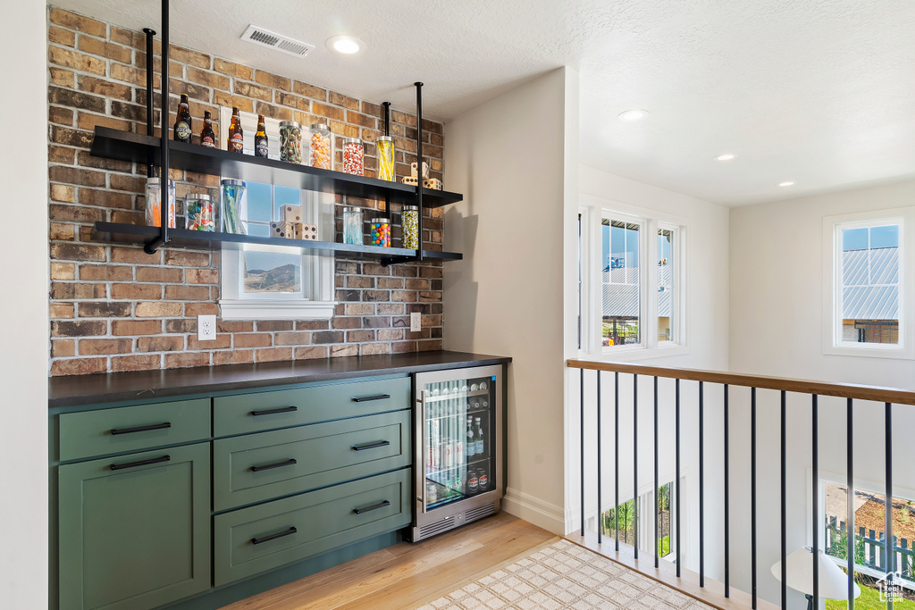Bar featuring a dry bar, wine cooler, visible vents, and a wealth of natural light