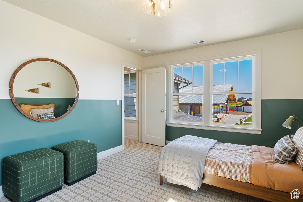 Bedroom with carpet, visible vents, and baseboards