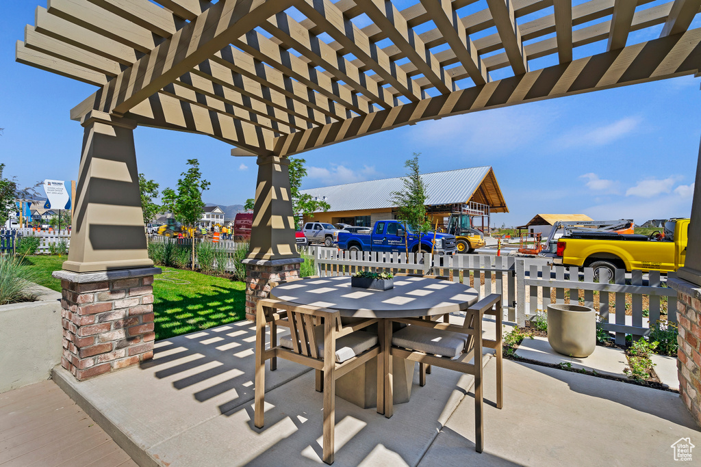 View of patio / terrace with fence, a pergola, and outdoor dining space