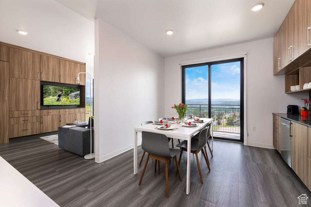 Dining space with dark wood finished floors, baseboards, and recessed lighting