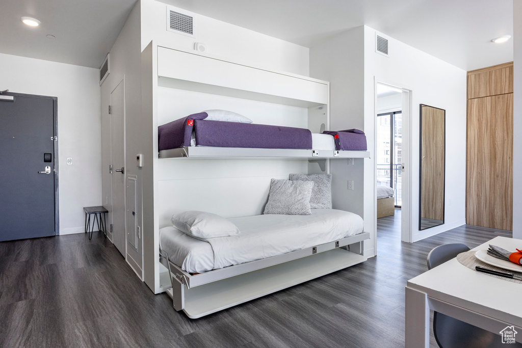 Bedroom with dark wood-type flooring and recessed lighting