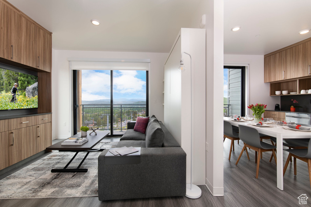 Living area with wood finished floors and recessed lighting