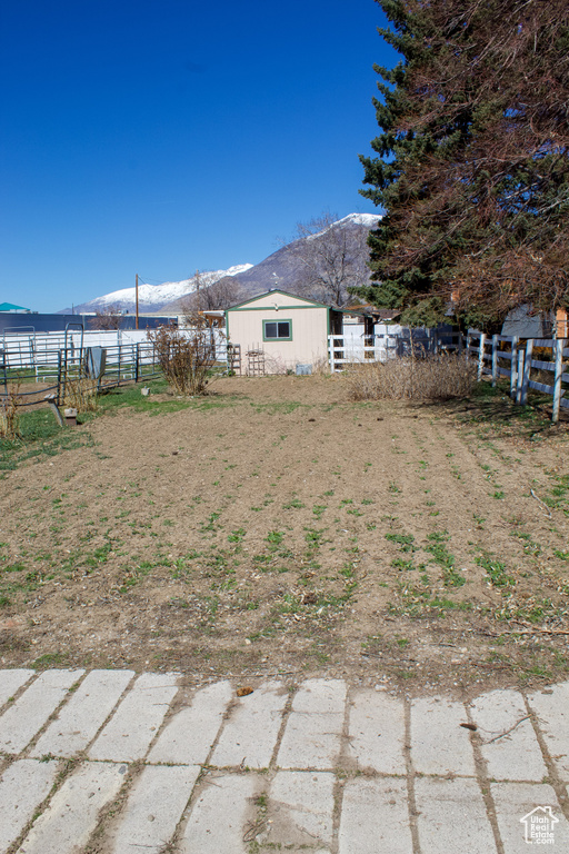 View of yard with an outdoor structure and fence