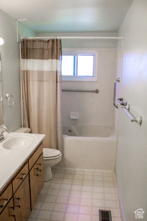Full bath featuring tile patterned floors, toilet, vanity, shower / tub combo, and visible vents