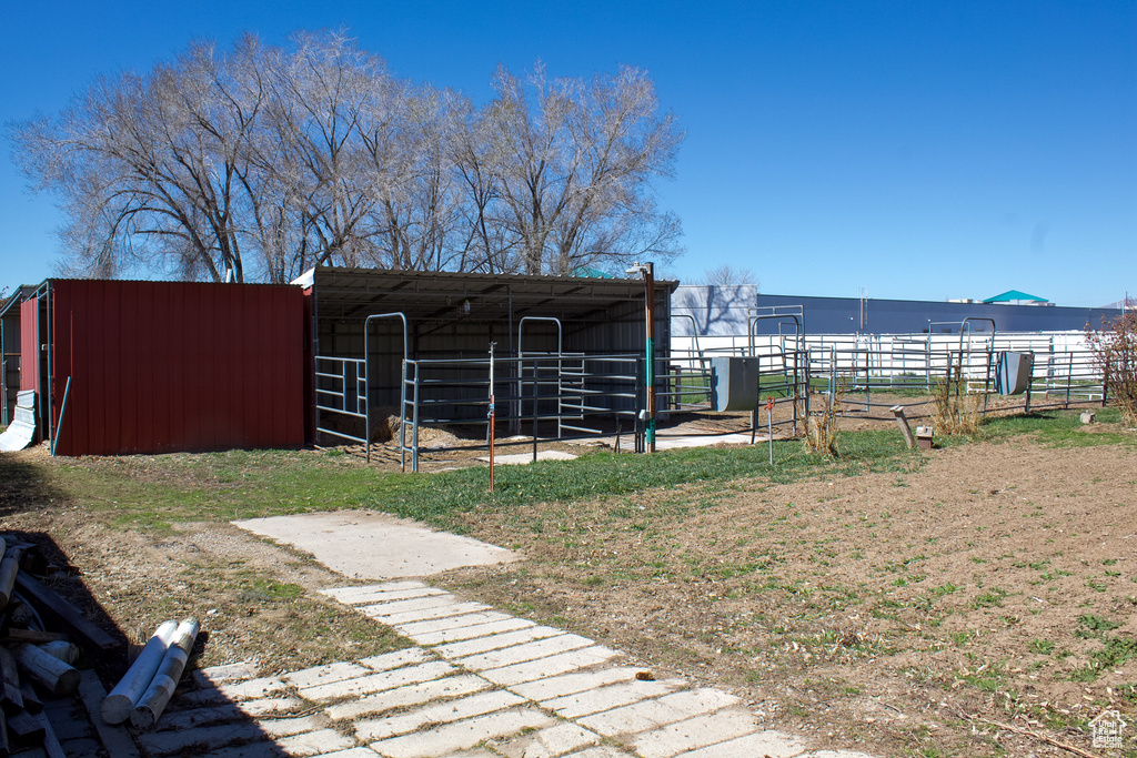 View of yard featuring an outdoor structure and an exterior structure