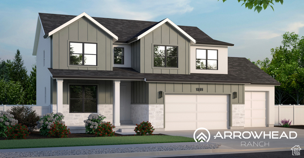 View of front of home with stone siding, board and batten siding, and concrete driveway