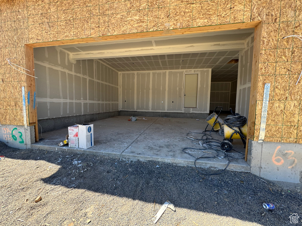 Garage featuring an attached carport