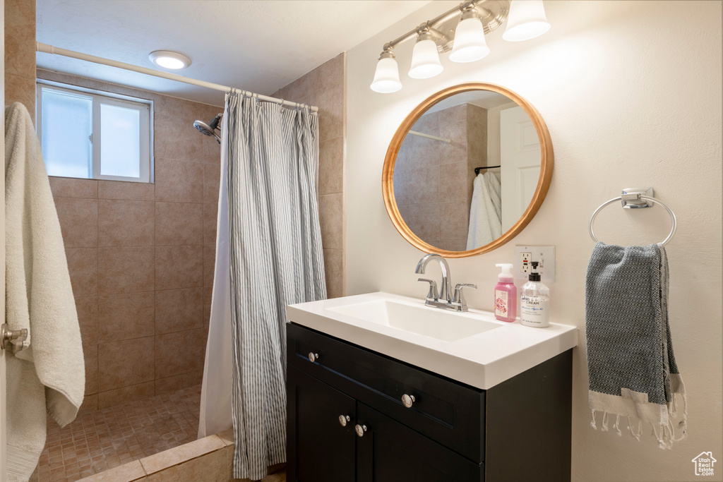 Bathroom with vanity and tiled shower