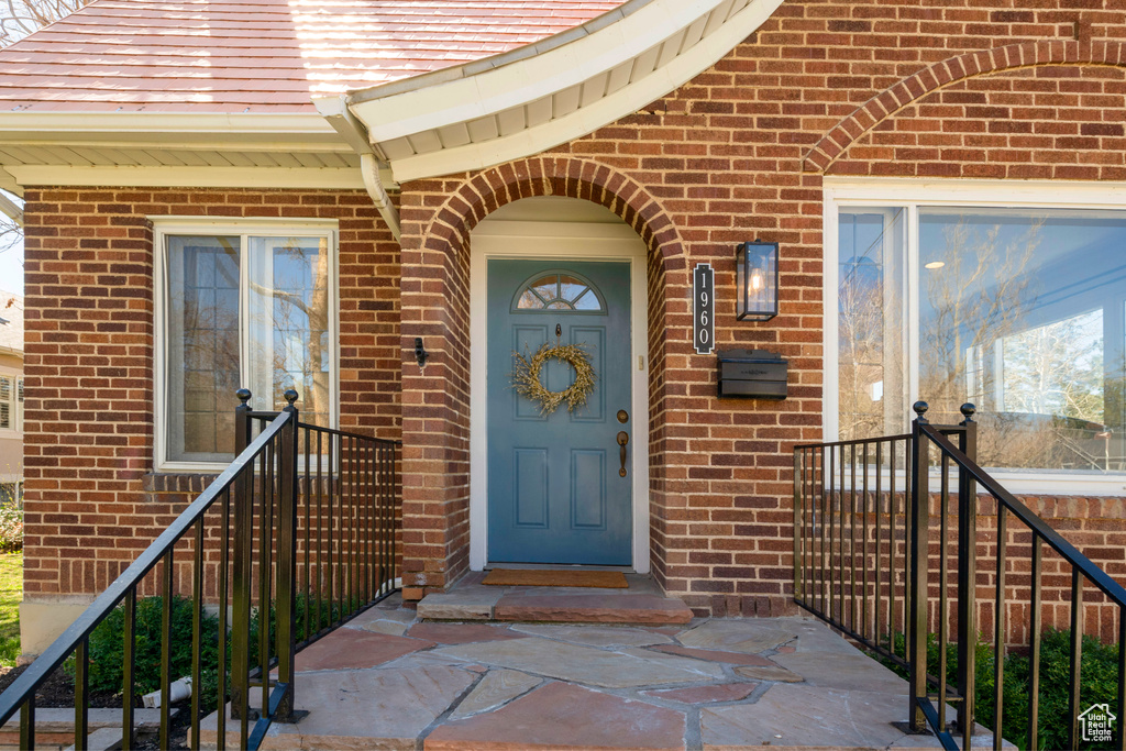 Property entrance featuring brick siding