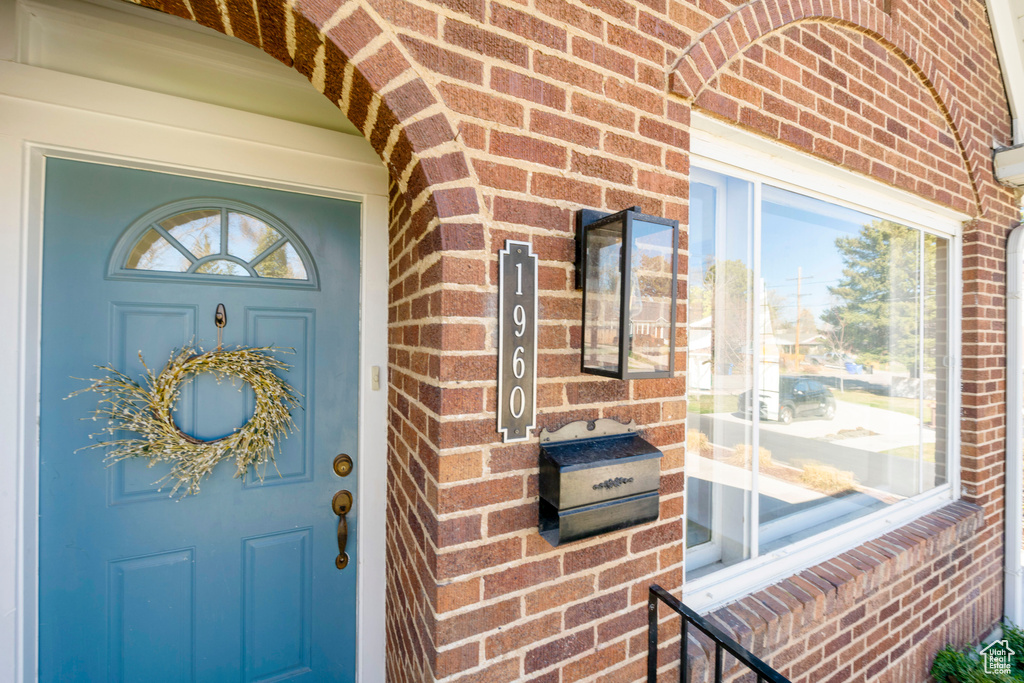Entrance to property with brick siding