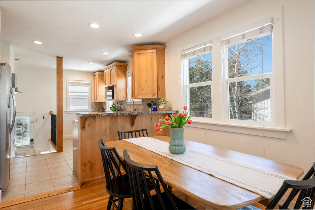 Dining space featuring recessed lighting and light tile patterned floors