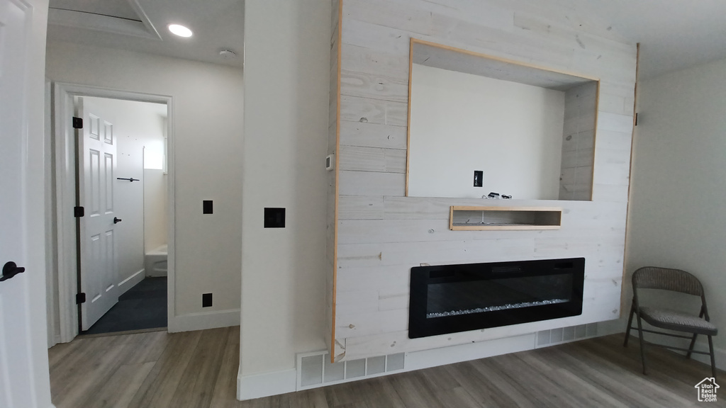 Hallway with wood finished floors, baseboards, and recessed lighting