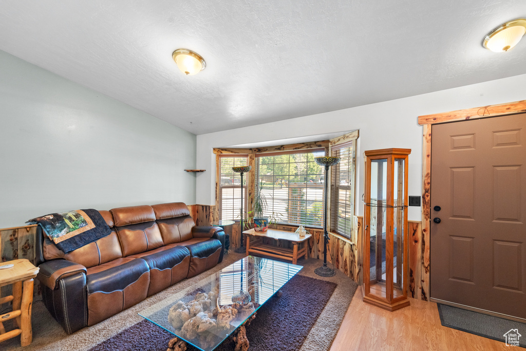Living area featuring light wood-style floors and wooden walls