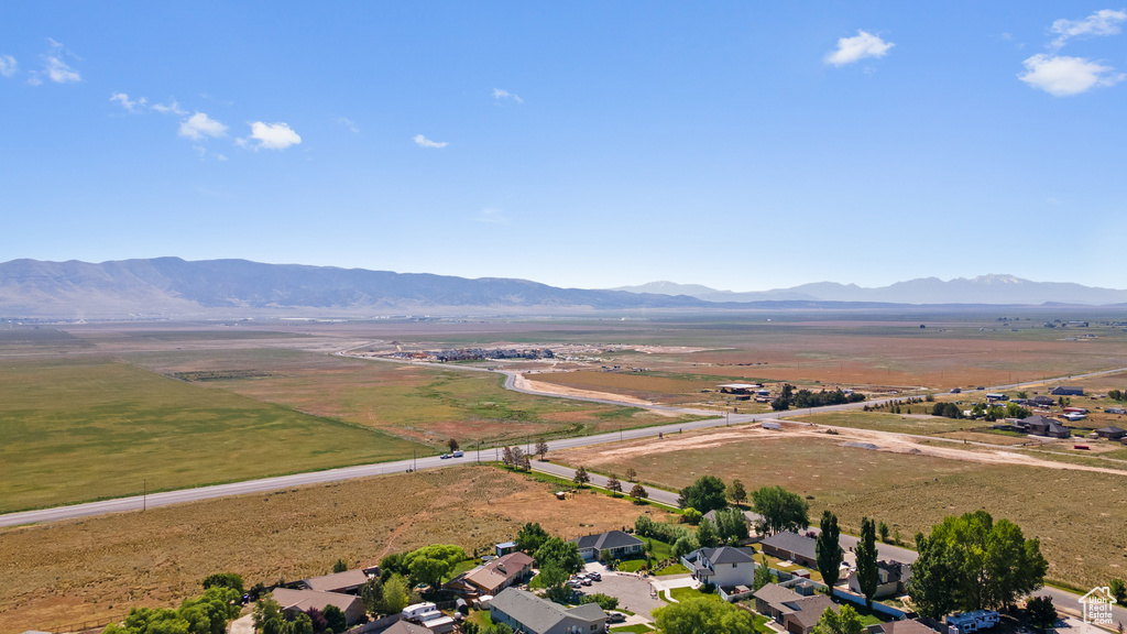 Aerial view of property's location with a mountainous background and rural landscape