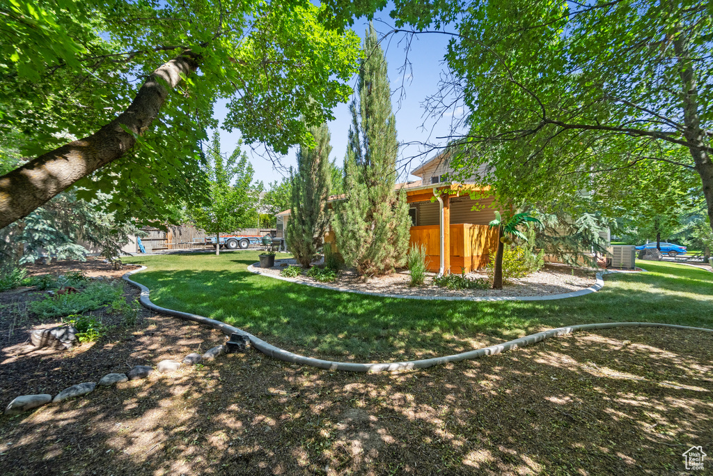 View of grassy yard with central AC