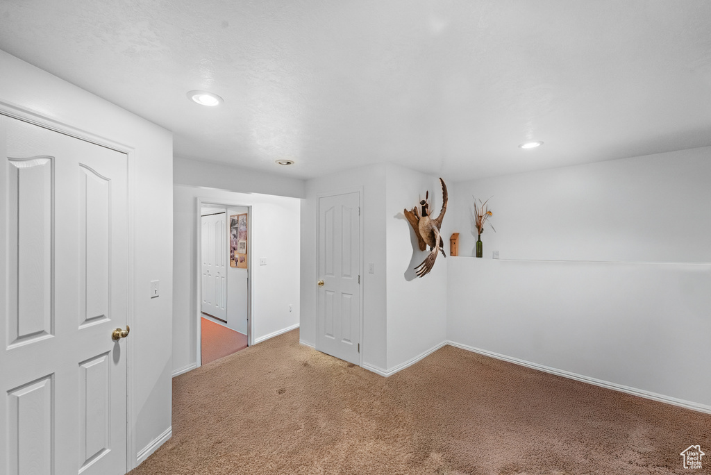 Unfurnished room with carpet flooring, baseboards, and recessed lighting