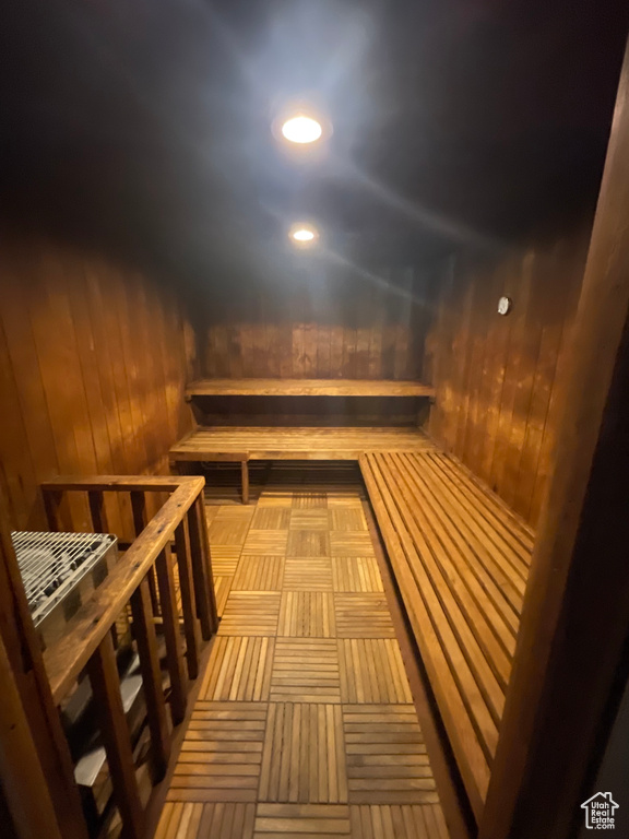 Relaxing sauna with wood walls and recessed lighting