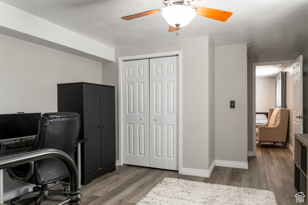 Home office featuring baseboards, wood finished floors, and ceiling fan