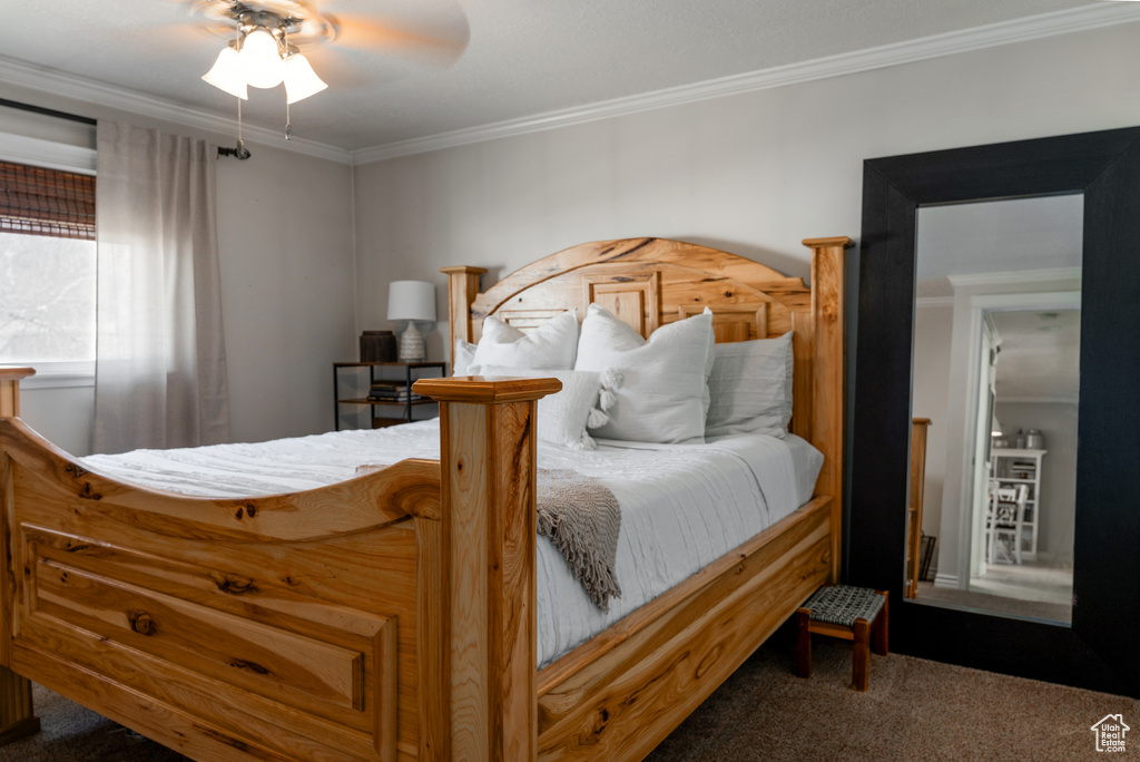Bedroom featuring ornamental molding, carpet, and a ceiling fan
