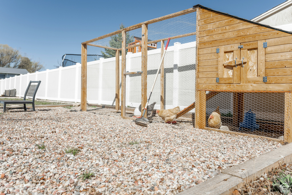 View of poultry coop with a fenced backyard