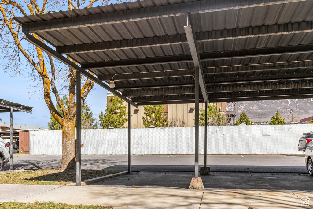 View of parking / parking lot featuring fence