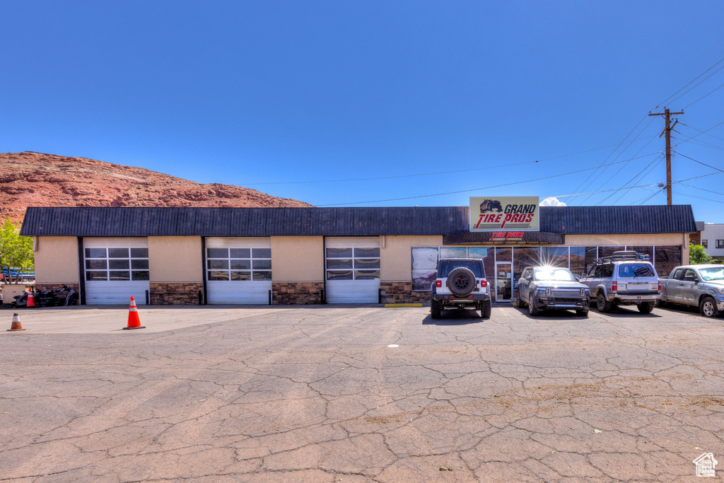 View of property featuring uncovered parking