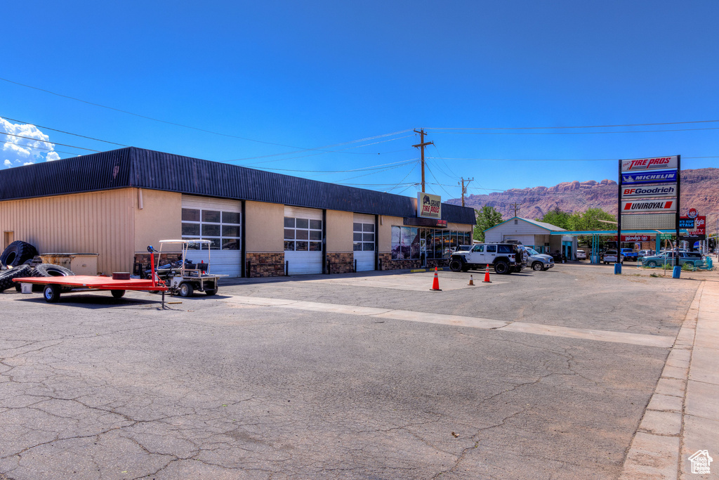 View of building exterior featuring uncovered parking