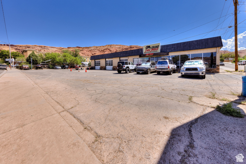 Uncovered parking lot featuring a mountain view