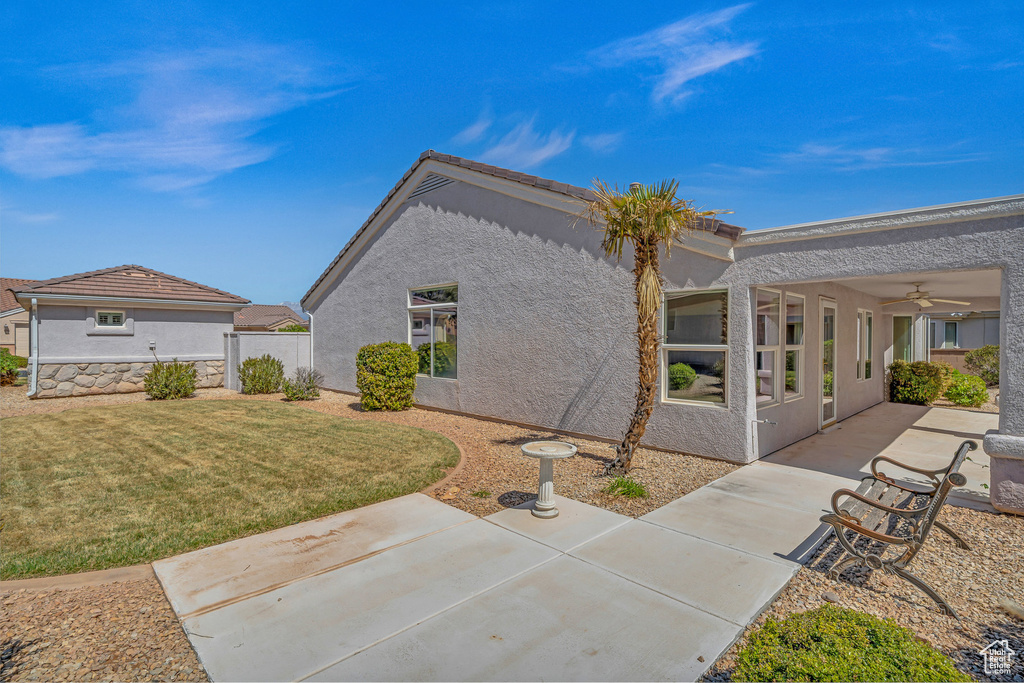 Back of house featuring a patio area, stucco siding, and ceiling fan