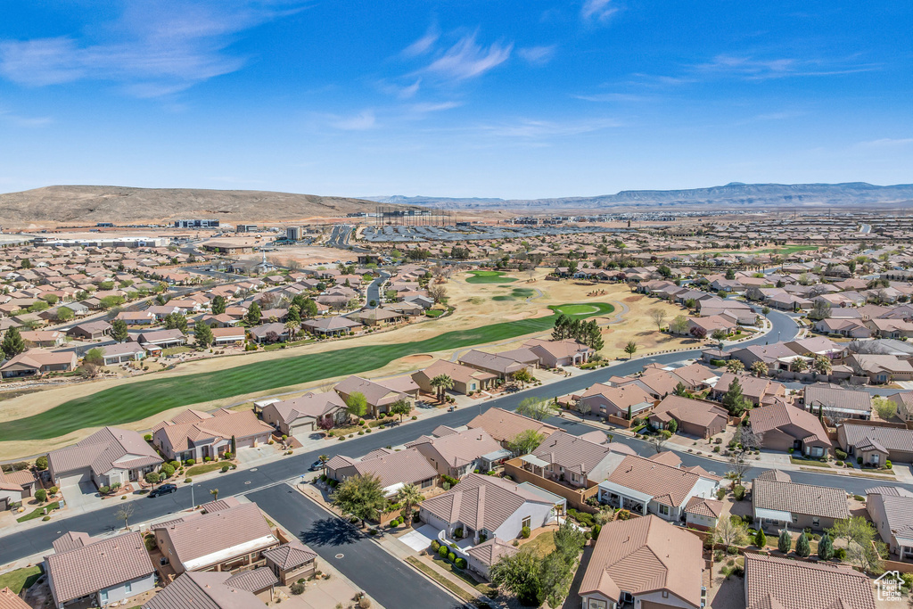 Aerial perspective of suburban area featuring mountains and a golf course
