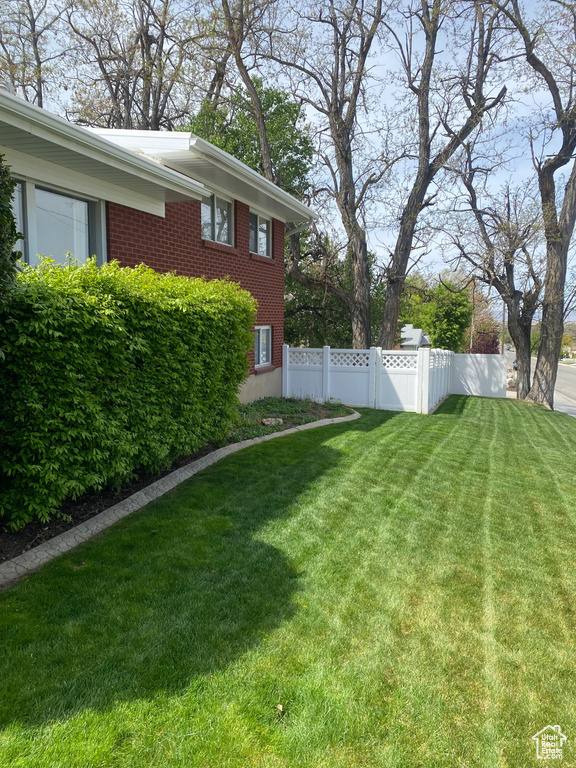 View of yard featuring fence