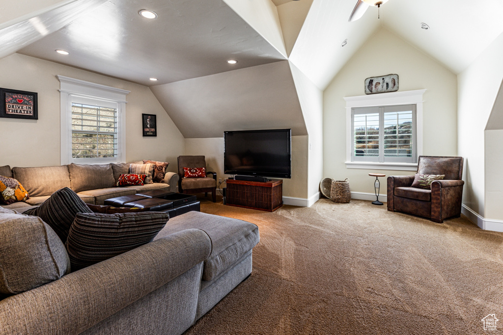 Living room featuring lofted ceiling, healthy amount of natural light, carpet flooring, recessed lighting, and a ceiling fan