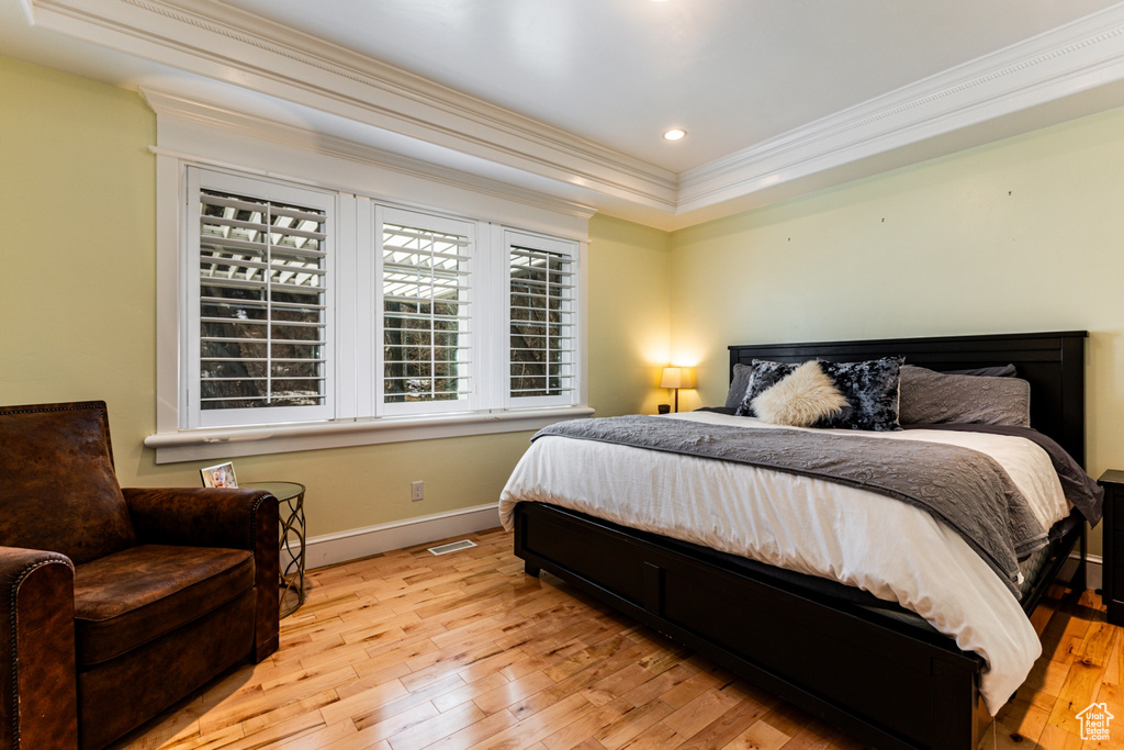 Bedroom with crown molding, light wood-type flooring, and recessed lighting