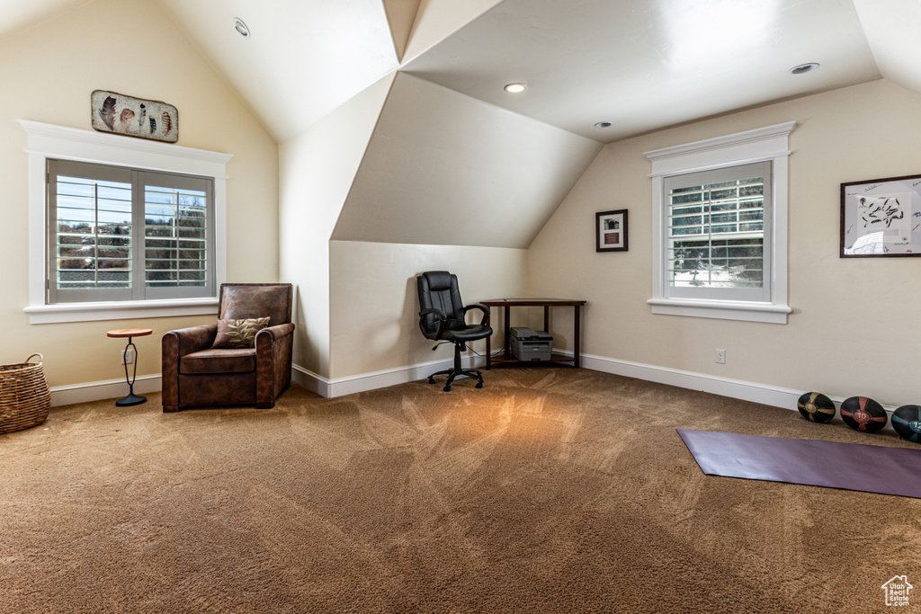 Living area with vaulted ceiling and carpet