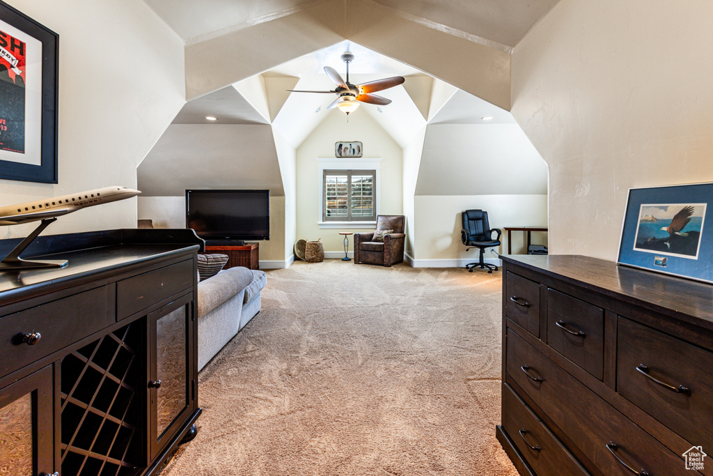 Bedroom featuring light carpet and vaulted ceiling