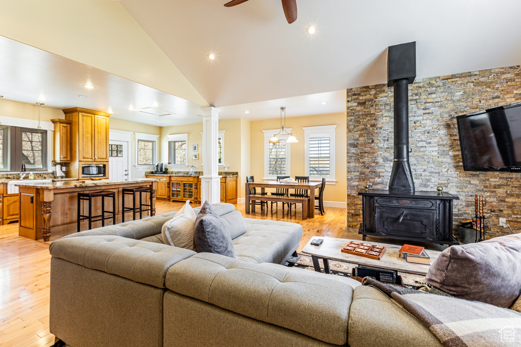 Living room with vaulted ceiling, light wood-type flooring, recessed lighting, ceiling fan, and healthy amount of natural light