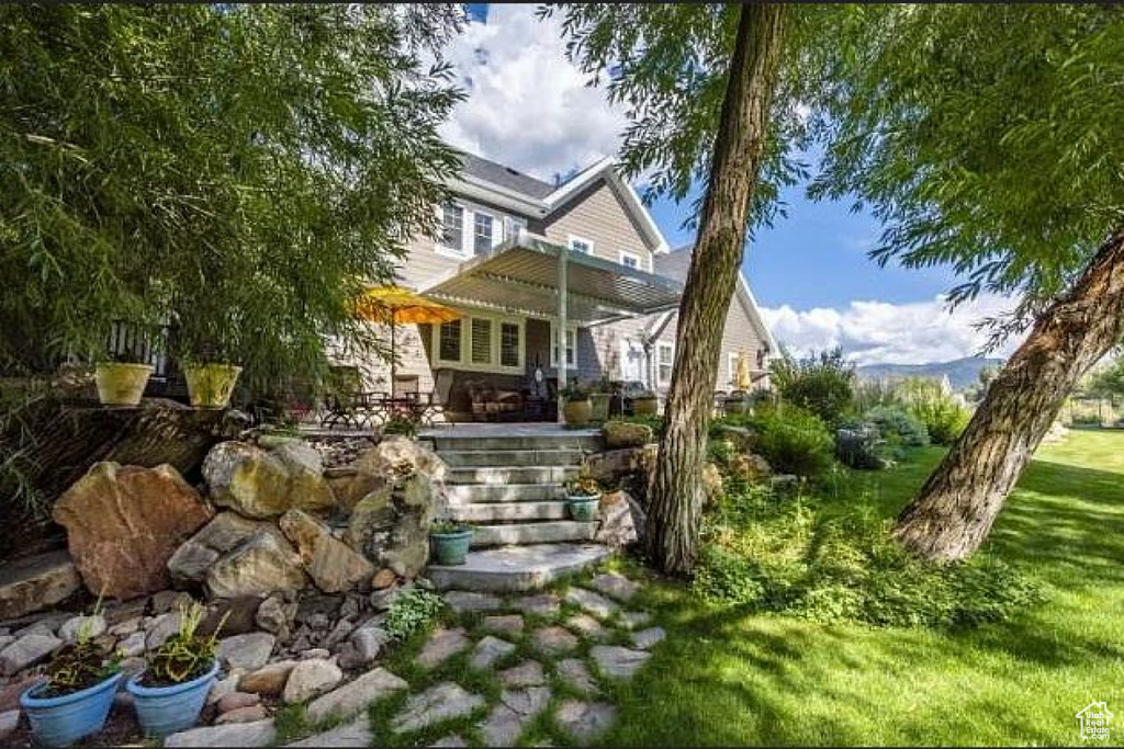 View of front of home featuring a pergola
