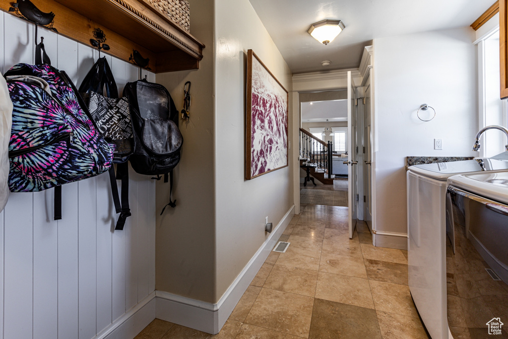 Corridor with washer and dryer and stairs