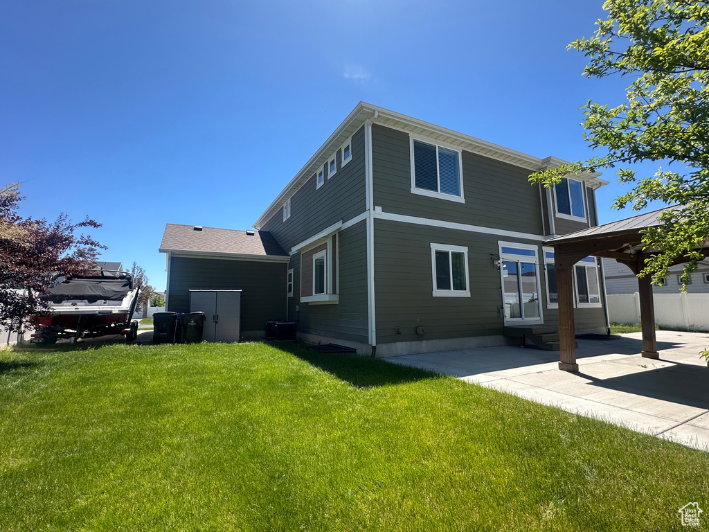 Rear view of house with a patio area and a gazebo