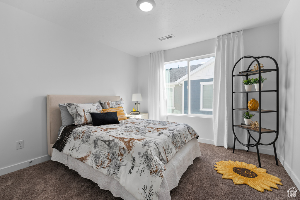 Bedroom featuring baseboards, visible vents, and carpet floors
