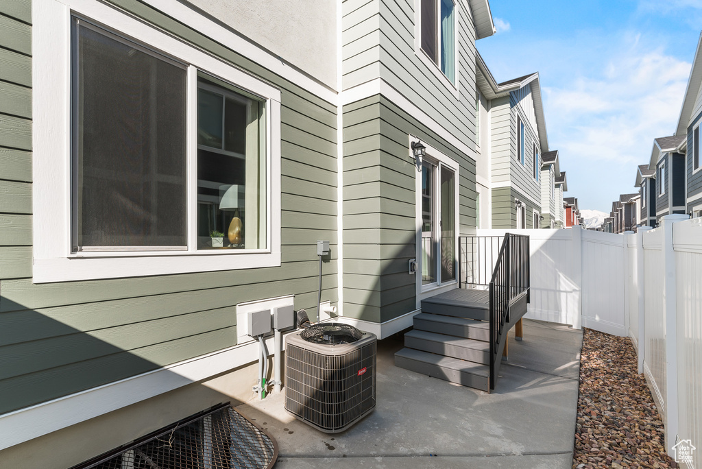View of patio with central air condition unit and a fenced backyard