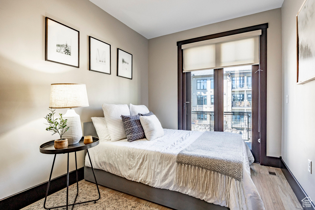 Bedroom with baseboards and wood finished floors