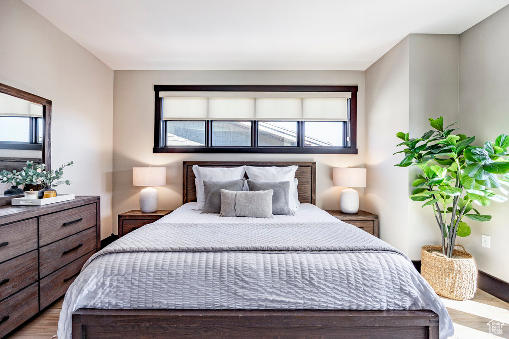 Bedroom with multiple windows and wood finished floors