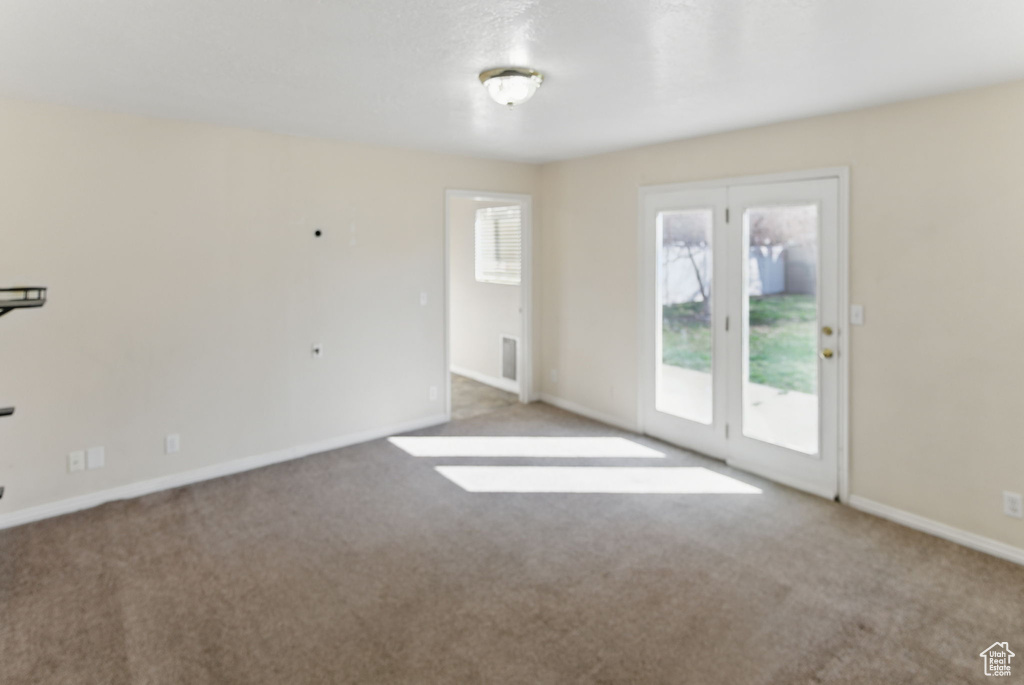 Spare room with baseboards and carpet flooring