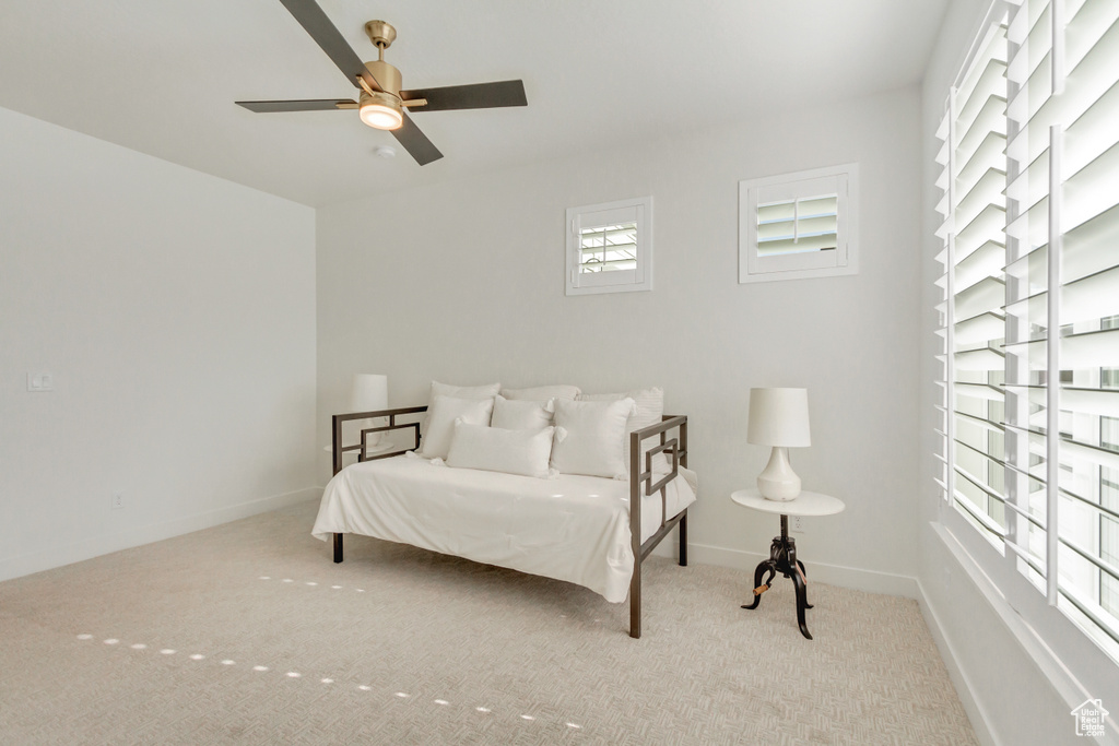 Carpeted bedroom featuring baseboards and ceiling fan