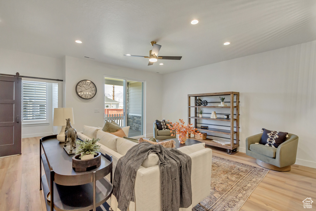 Living area with baseboards, light wood-style flooring, recessed lighting, and a ceiling fan