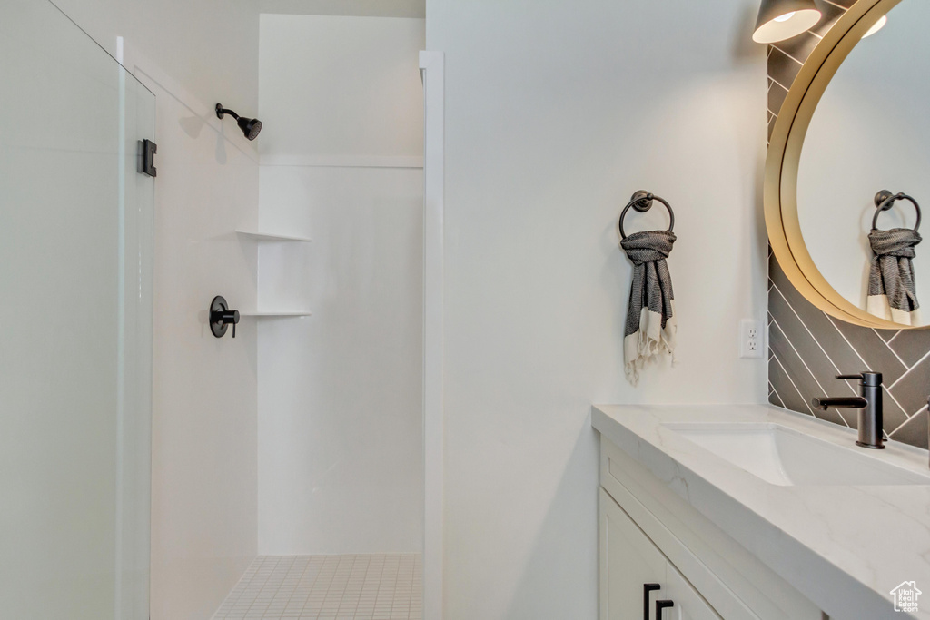 Bathroom featuring a shower and vanity